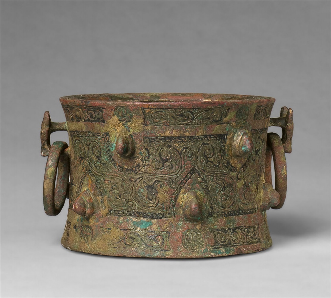 A rare mortar with two animal head handlesChased cast bronze with damascening (?), red pigment,