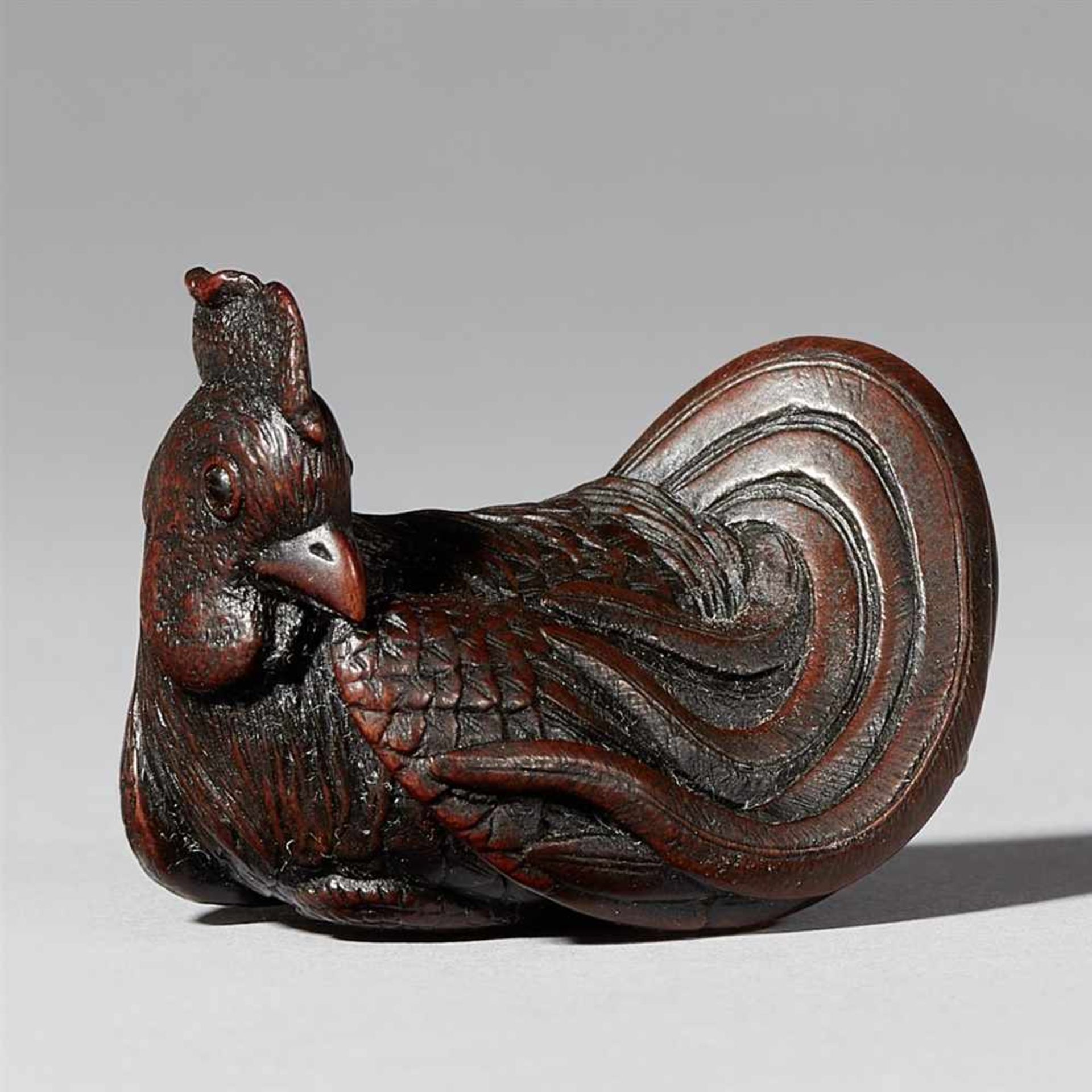 A fine wood netsuke of a rooster, by Itsumin. 19th century