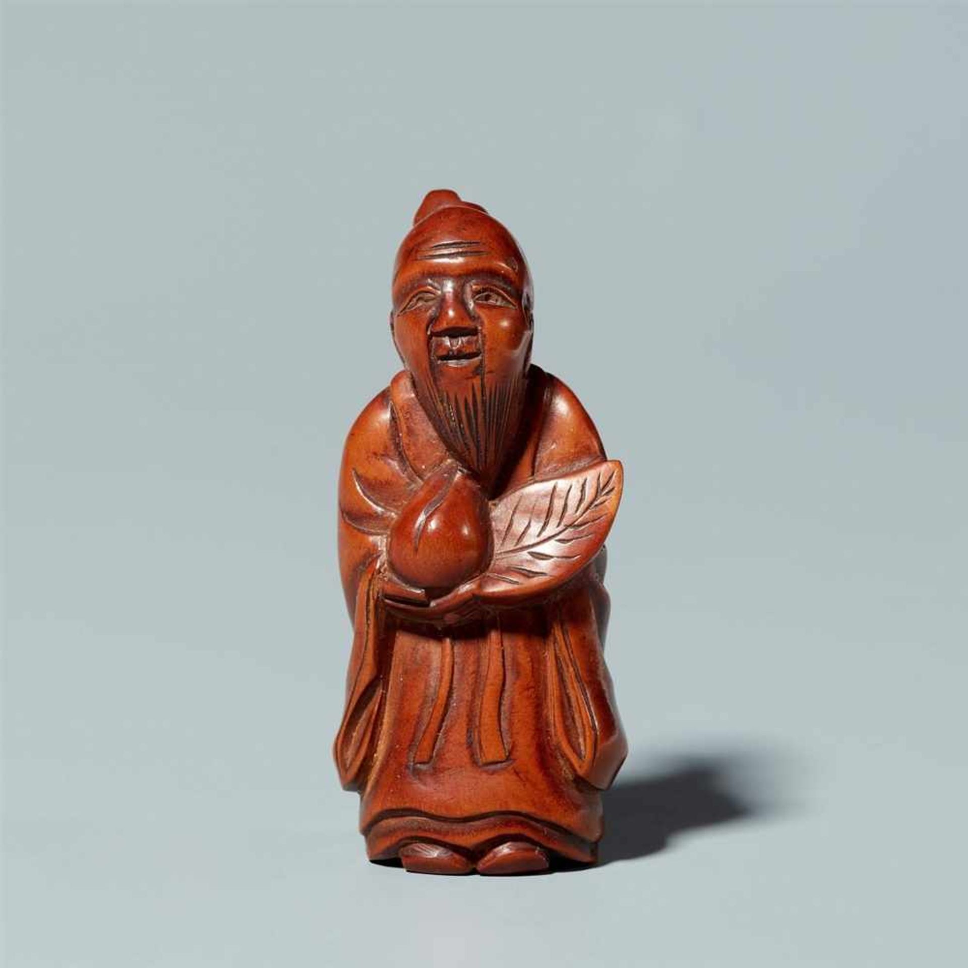 A boxwood netsuke of a sage. Around 1900