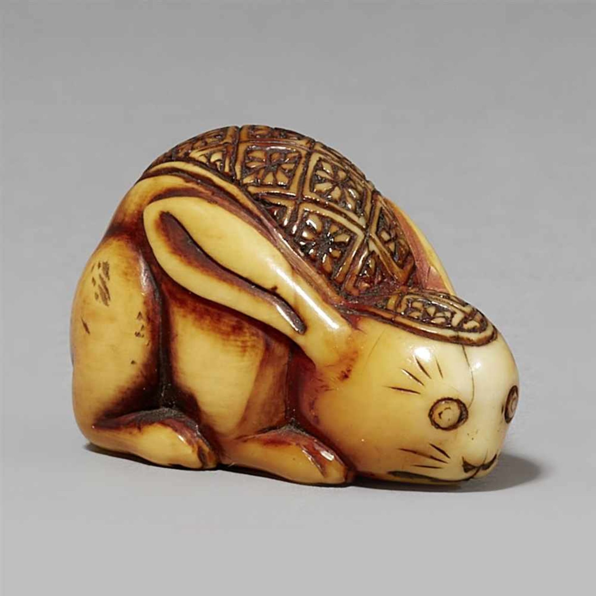 An ivory netsuke of a hare, by Rakuzan. 19th century