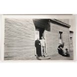 Photograph. Neruda with his father in the door of the house in Temuco, Chile. 7x10 cm. Black and