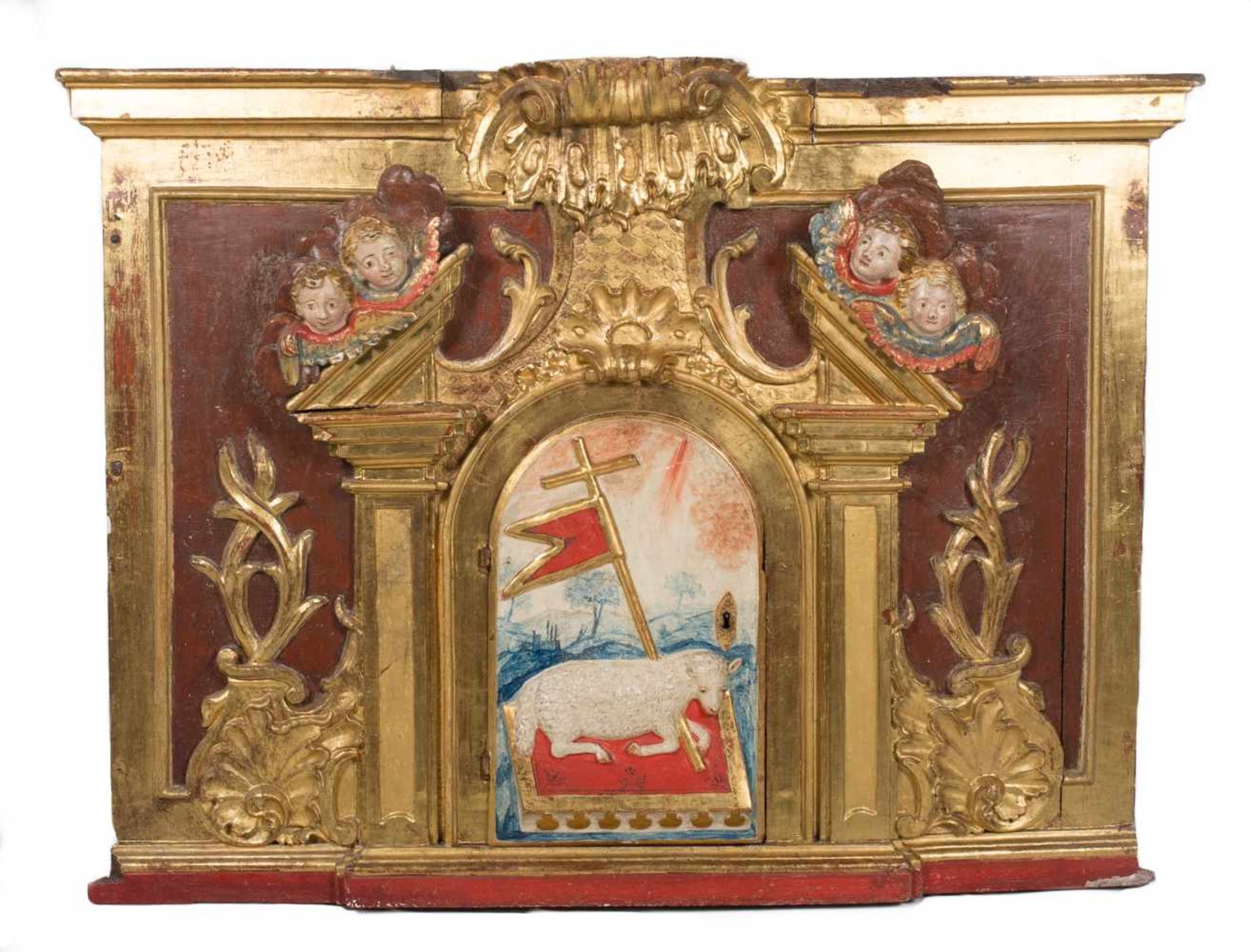 Part of an altarpiece which includes the carved, gilded and polychromed door to the tabernacle.