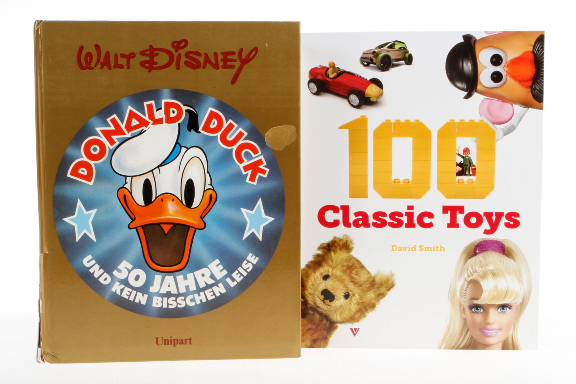 2 Bücher "Donald Duck" und "100 Classic Toys", Alterungsspuren