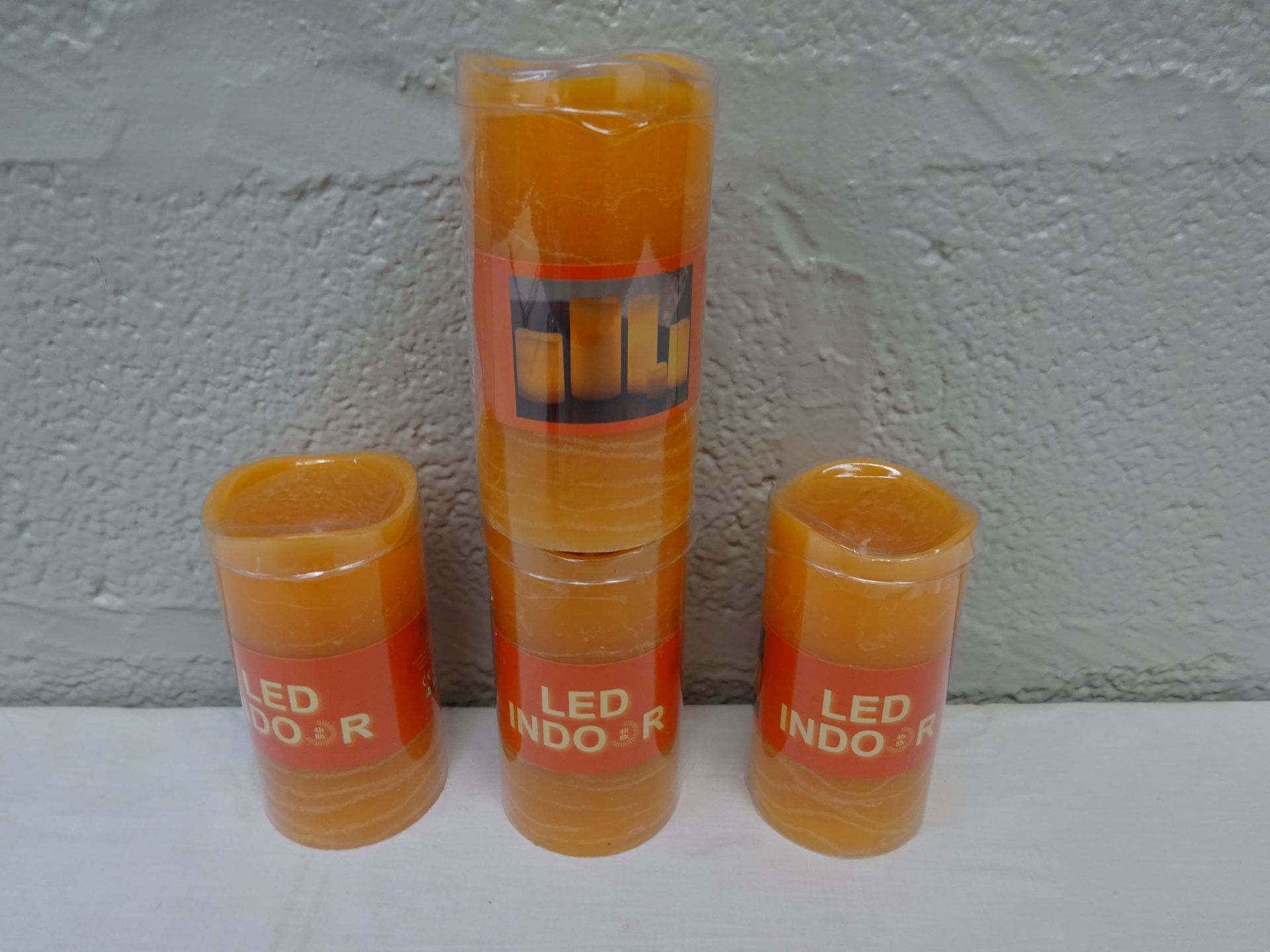 BRAND NEW X4 ORANGE WAX LED INDOOR BATTERY POWERED CANDLES.