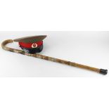 Walking stick with several Military Cap Badges attached, plus a Soviet Military Cap. (Buyer