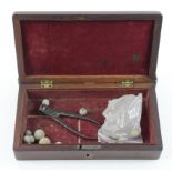 Pistol case for 19th century gun containing a bullet mold and various musket balls