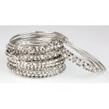 Twenty four white metal (tests as silver) bangles, total weight 118.4g