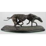 Greyhound interest. A cast spelter figure depicting two racing greyhounds in action, on a wooden