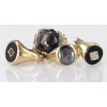 Four 9ct Gold hallmarked and yellow metal (tests as 9ct) Onyx Rings weight 19.8g