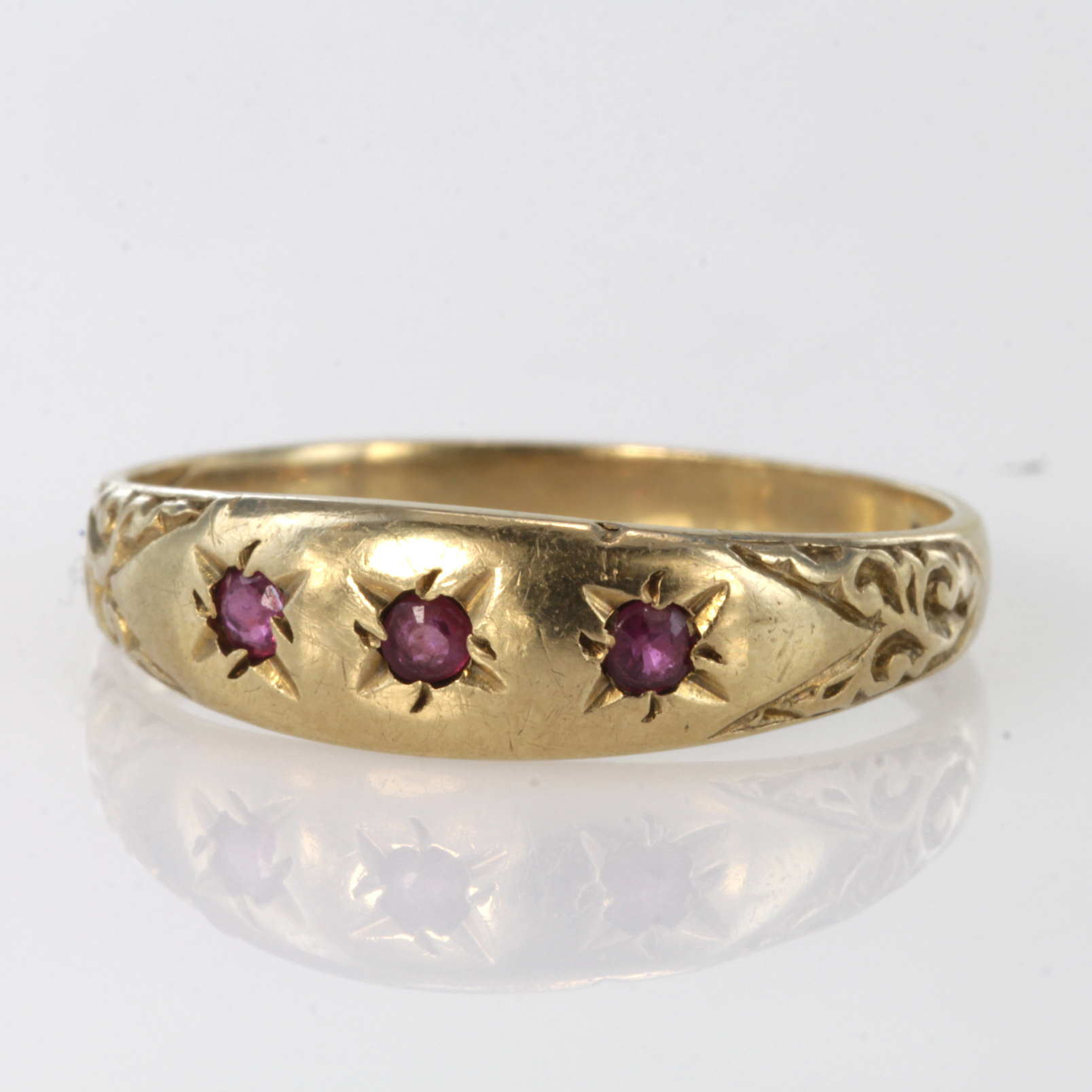 9ct hallmarked Gypsy style Ring set with three Rubies size O weight 1.9g