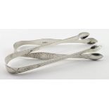 Two pairs of silver, bright-cut Georgian sugar tongs - one is hallmarked Peter, Ann & William