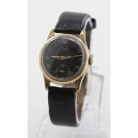 Gents Tissot wristwatch circa 1940. The gold filled case with a black dial, arabic numerals and