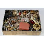 Selection of old costume jewellery in a biscuit tin