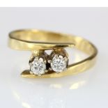 18ct Gold Diamond two stone Ring of Crossover Design, approx. diamond weight 0.25ct total. Finger