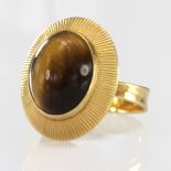 Yellow metal Ring tests as approx 18ct set with large oval Tigers Eye stone size N weight 5.2g