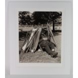 Social History, 16 x 20" photograph of a Hyde Park attendant asleep under a stack of deckchairs,