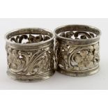 Two attractive silver napkin rings, one with very rubbed hallmarks and the other hallmarked