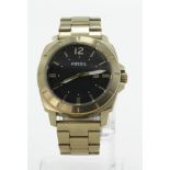 Gents Fossil Wristwatch. The 46mm black dial with gilt bezel and on a gilt strap. Working when