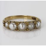 Yellow metal marked 18ct Ring set with five Pearls size L weight 2.8g