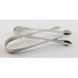 Two pairs of bright-cut Georgian silver sugar tongs - one hallmarked for Saml. Godbehere and