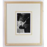 The Beatles, 8 x 10" photograph of George Harrison tuning his guitar, taken from the original