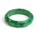 Green Jade (?) bangle, with bird and foliage decoration, diameter 60mm approx.