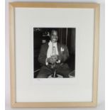 Louis Armstrong, 8 x 10" photograph seated with his trumpet, taken from the original negative,