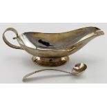 Silver sauce boat with silver sauce ladle hallmarked "HRS London, 1963". Weight of both items 5.5 oz