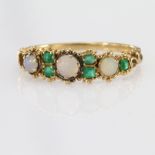 Yellow metal Ring tests as 15ct set with Emeralds and Opals (one missing) weight 1.5g
