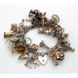 Silver/white metal charm bracelet with a good selection of charms attached. Total weight118.2g