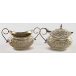 Ornate silver mustard pot and salt (no liners) both hallmarked CTB Birmingham 1909. Weighs 3oz