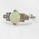 White metal Ring marked 18ct Plat. set with central Opal with six Diamonds surround size M weight