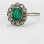 White metal Ring tests as Palladium ? with central Emerald surrounded by 12 old cut Diamonds size