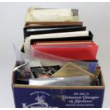 World lot in a packed box, stuffed with albums and stockbooks, plenty of loose material in