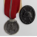 German Nazi Russian Front Medal, and Black Wounds Badge maker marked '107'. (2)