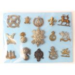 Cap Badges on a blue card - inc 13x Infantry and 2x London Regt. (15)