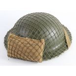 WW2 British Tommy Helmet with cam net and field dressing.
