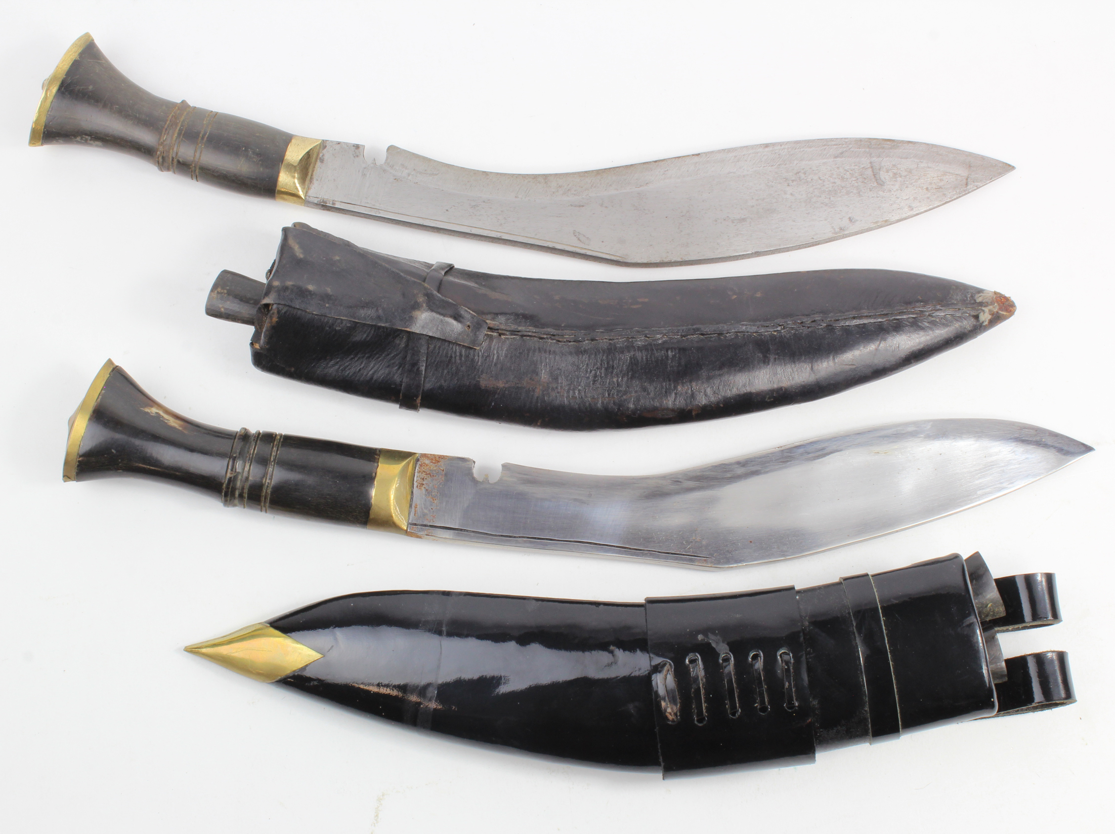 Kukris - tourist Kukris in their leather scabbards. One with two Knives (Chakmak and Karda) and