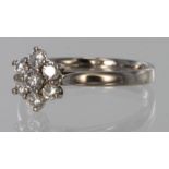 18ct white gold daisy cluster diamond ring set with seven diamonds totalling approx. 0.33ct.