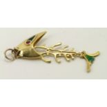 18ct yellow gold pendant in the shape of fish bones with green enamel decoration and red eyes,