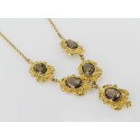 9ct yellow gold necklace consisting of five ornate links set with a single oval smoky quartz on a