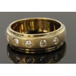 9ct yellow gold band ring set with five diamonds flush set in frosted finish centre section,