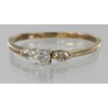 18ct ring set with central round diamond with a marquise diamond each side, total diamond weight 0.