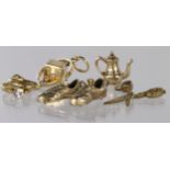 Five 9ct yellow gold charms to include scissors, rings, teapot, football boots and spinning dice.