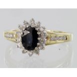 18ct yellow gold sapphire and diamond cluster ring with diamond set shoulders, diamond weight