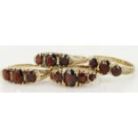 Four 9ct yellow gold garnet set rings, weight 10.9g