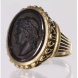 9ct dress ring set with oval jet carved to depict a Roman man, snapped ring shank and damage to jet,
