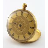 Ladies 18ct cased pocket watch, the gilt dial with black roman numerals and foliage decoration.