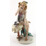 Capodimonte figure, depicting a female in stockings answering the telephone, titled to base 'L'