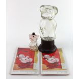 Bonzo collectables, comprising a glass model on an art deco bakelite base, a perfume figural